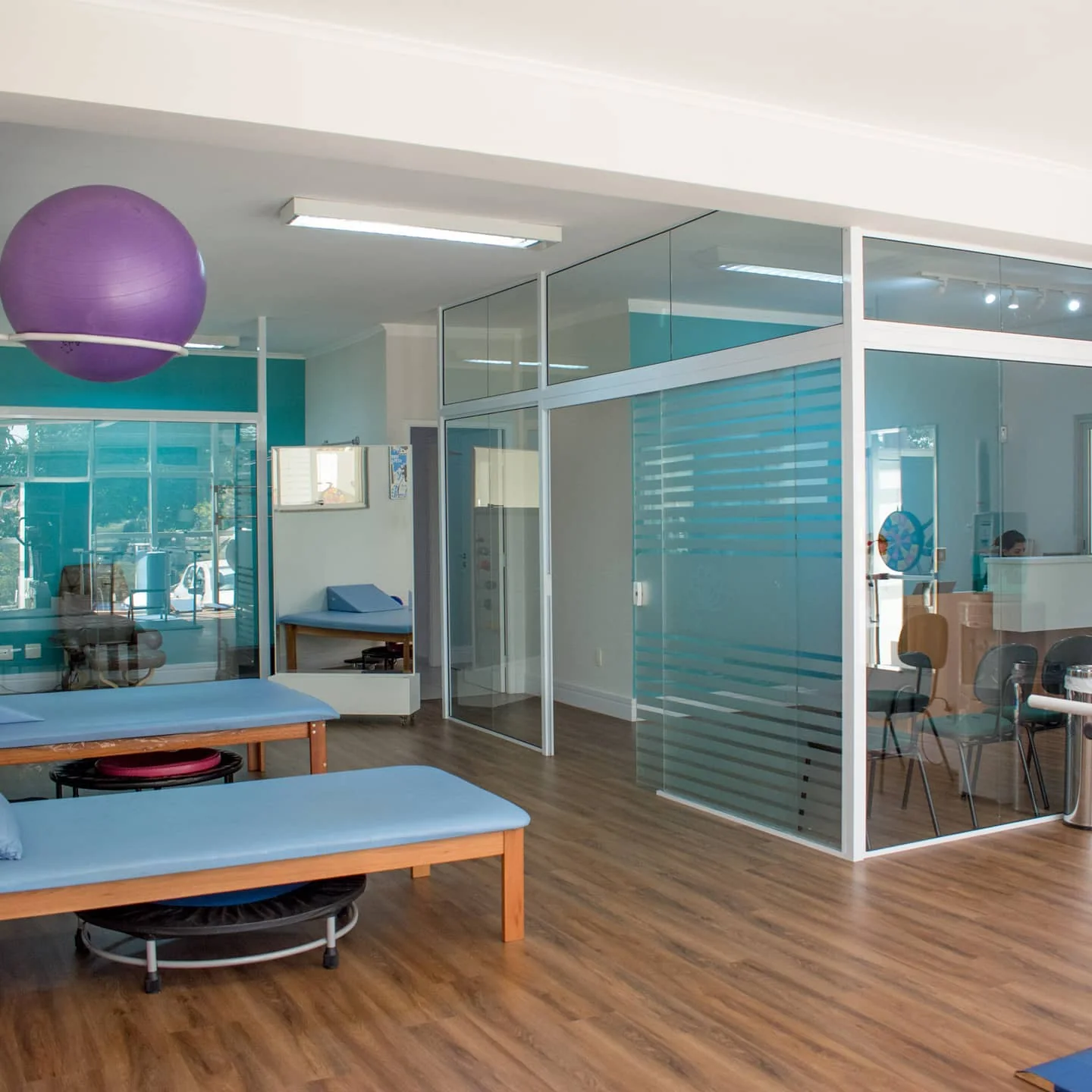 Sala de reabilitação do Instituto Neuron, com macas e salas de vidro